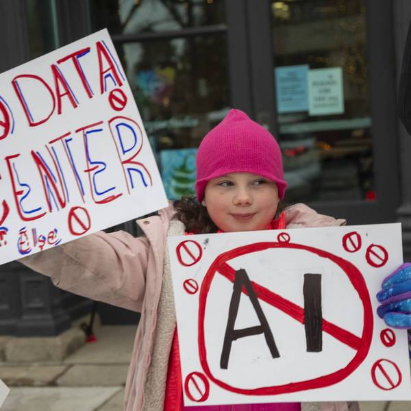 A child protester holds a sign reading, "No Data Center"