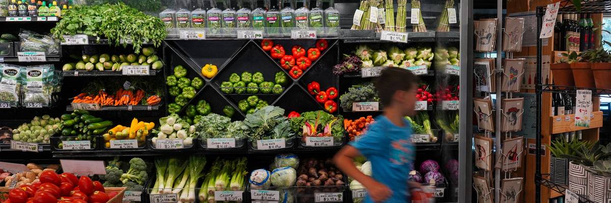 A child runs through the produce aisle