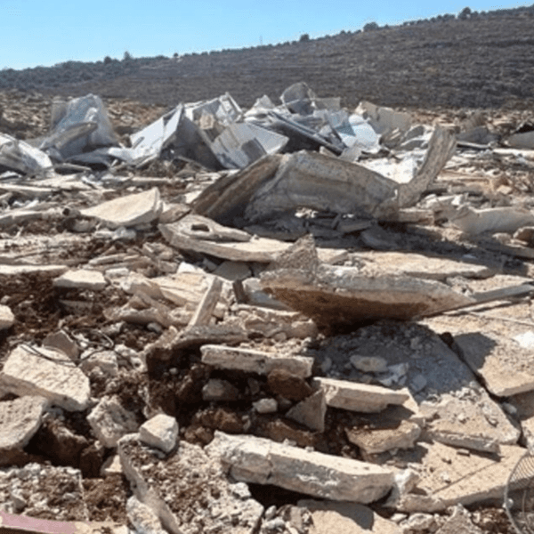 A child stands among the rubble after Israeli authorities demolished his family's home