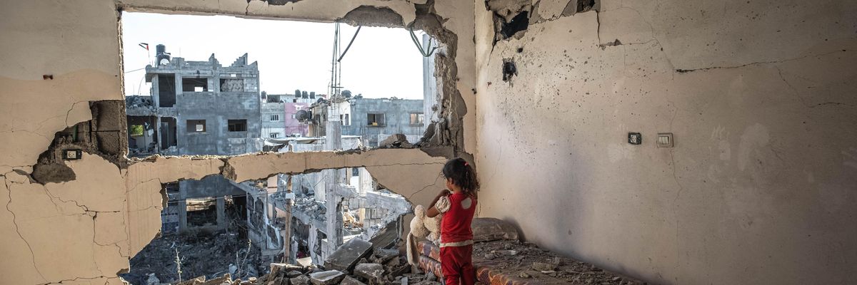 A child stands in a bombed-out apartment