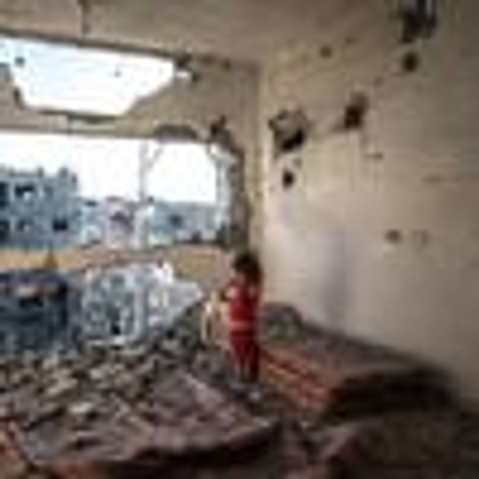 A child stands in a bombed-out apartment