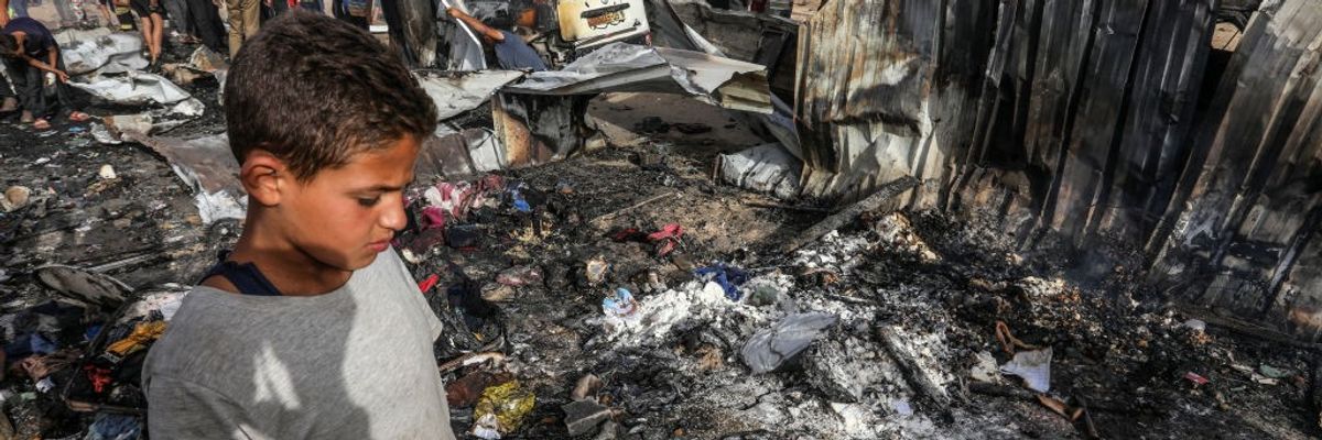 A child surveys rubble in Rafah.