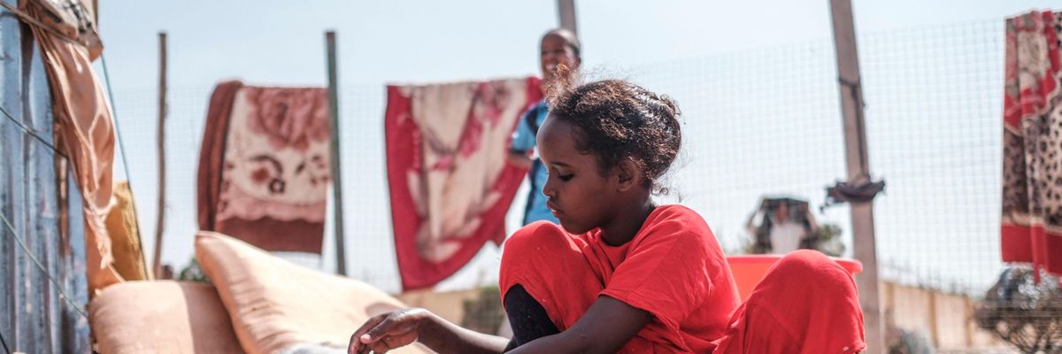 A child washing dishes in Somalia