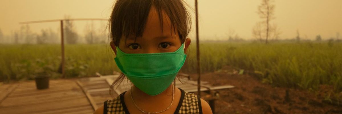 A child wears a face mask to protect from air pollution in Indonesia