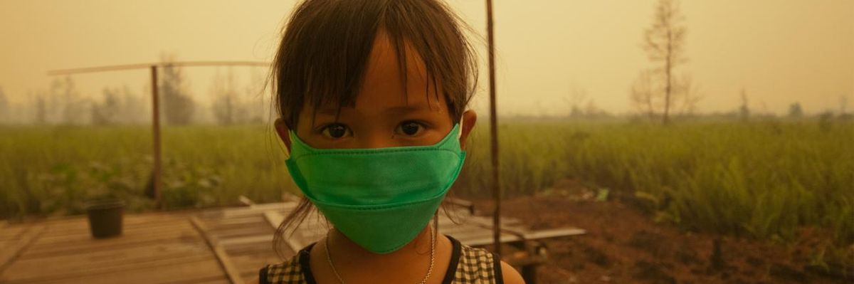 A child wears a face mask to protect from air pollution in Indonesia