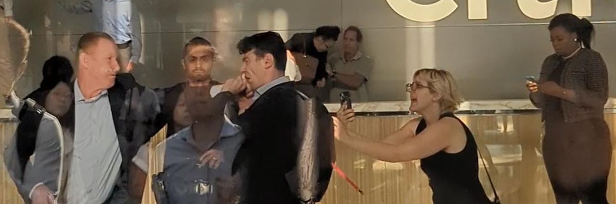 A Citibank staffer punches a climate protester