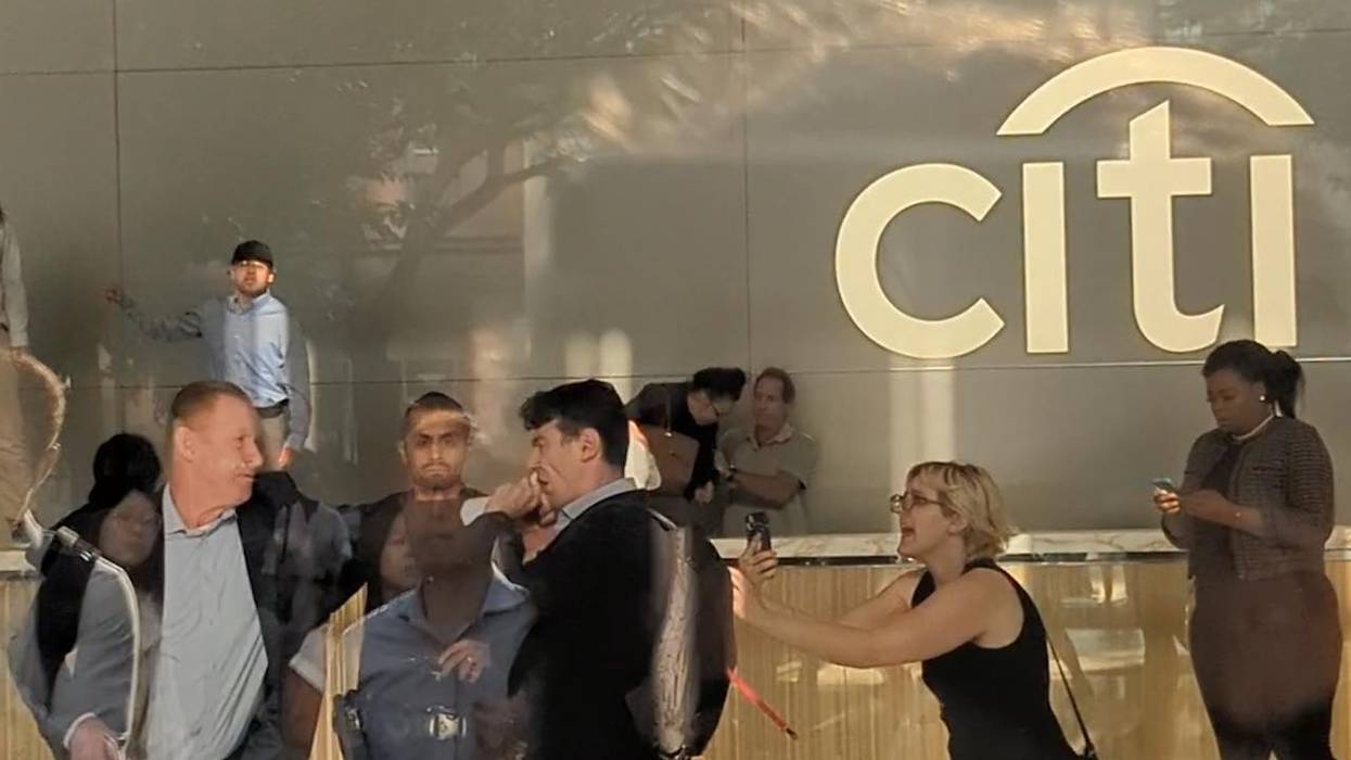 A Citibank staffer punches a climate protester