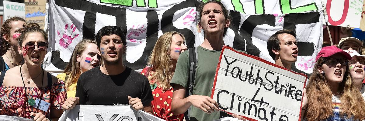 A climate activist holds a sign reading 'Youth strike 4 climate"