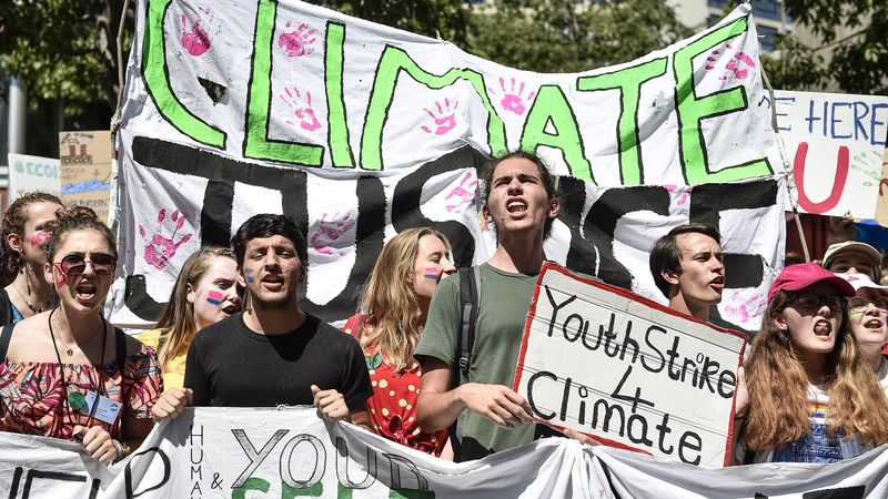 A climate activist holds a sign reading 'Youth strike 4 climate"