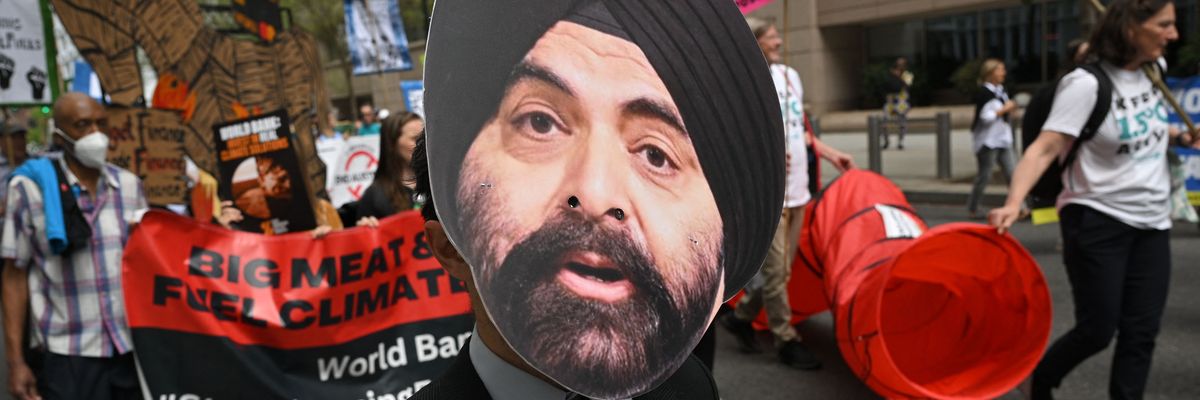 A climate activist wears a mask of incoming World Bank President Ajay Banga during a protest outside the bank's headquarters in Washington, D.C. on April 14, 2023.