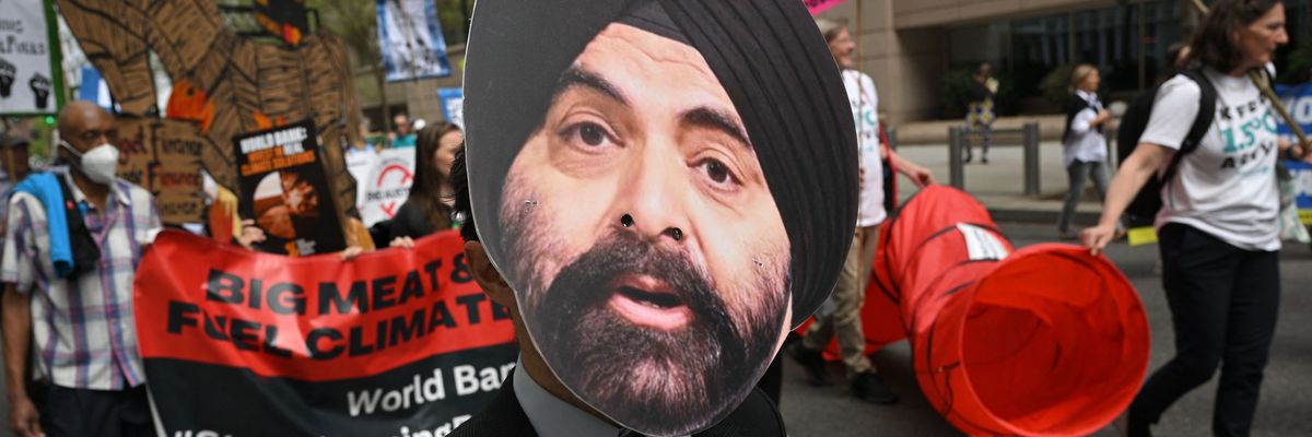 ​A climate activist wears a mask of incoming World Bank President Ajay Banga during a protest outside the bank's headquarters in Washington, D.C. on April 14, 2023.