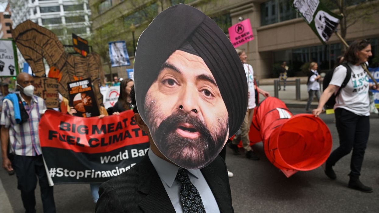 A climate activist wears a mask of incoming World Bank President Ajay Banga during a protest outside the bank's headquarters in Washington, D.C. on April 14, 2023.