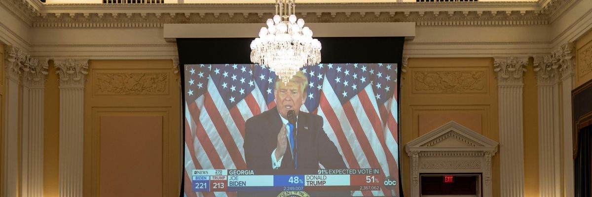 A clip of Donald Trump speaking is shown during a House hearing