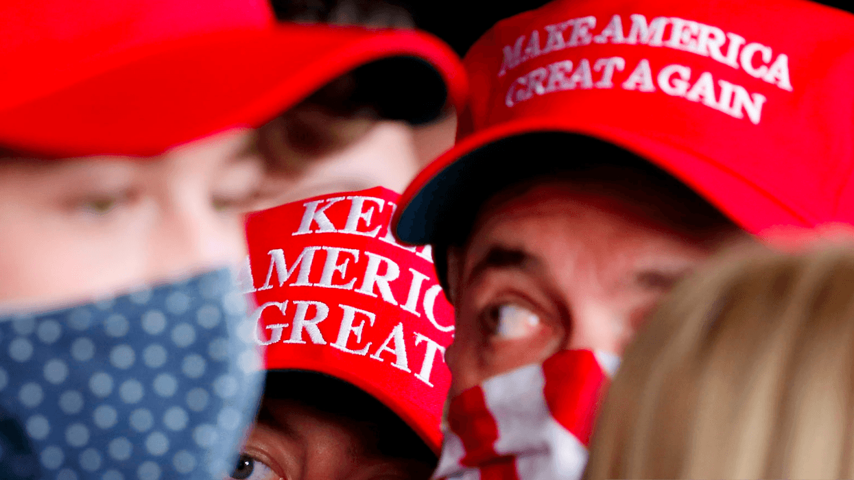 A close-up of people in MAGA hats.