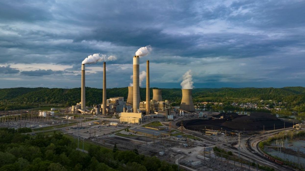 A coal plant emits smoke into the sky.