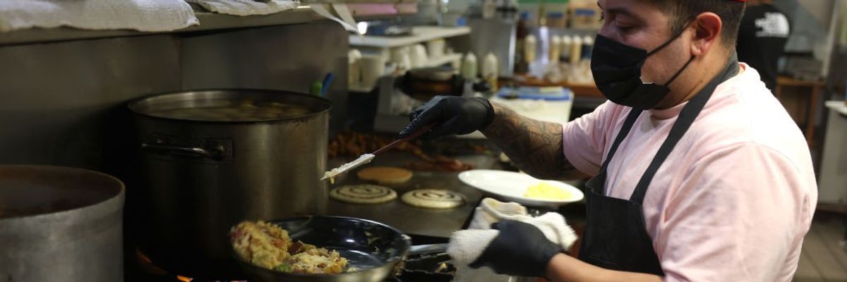 A cook makes scrambled eggs at Miracle Mile Cafe