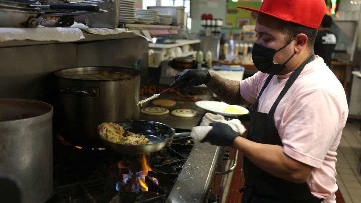 A cook makes scrambled eggs at Miracle Mile Cafe