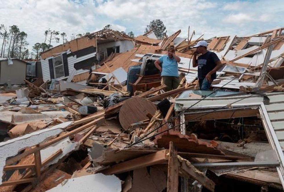 A couple react as they go through their destroyed mobile home following the passing of Hurricane Laura in Lake Charles, Louisiana, on August 27, 2020. (Photo: Andrew Caballero-Reynolds/ AFP via Getty Images)