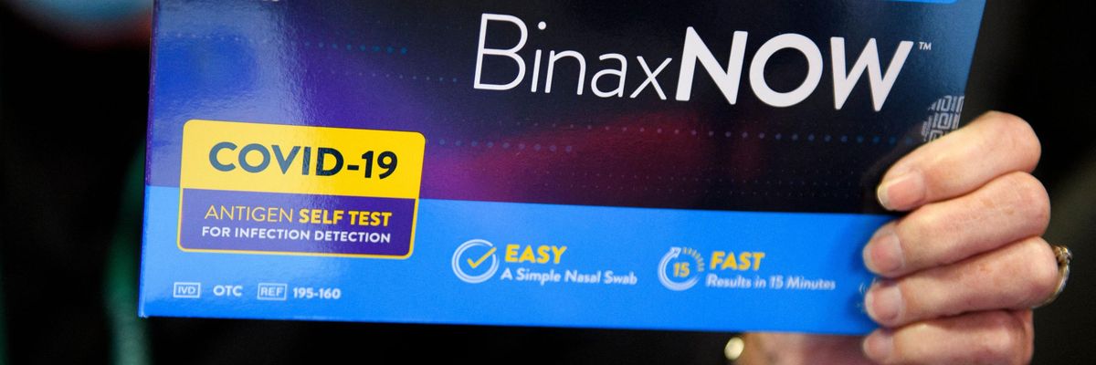 A Covid-19 test is displayed for a photograph