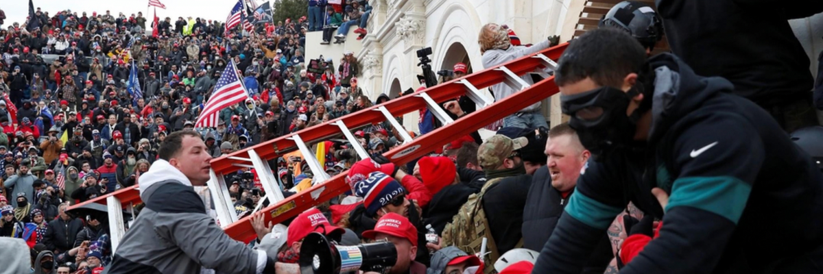 A crowd storms the U.S. Capitol with a red ladder. 