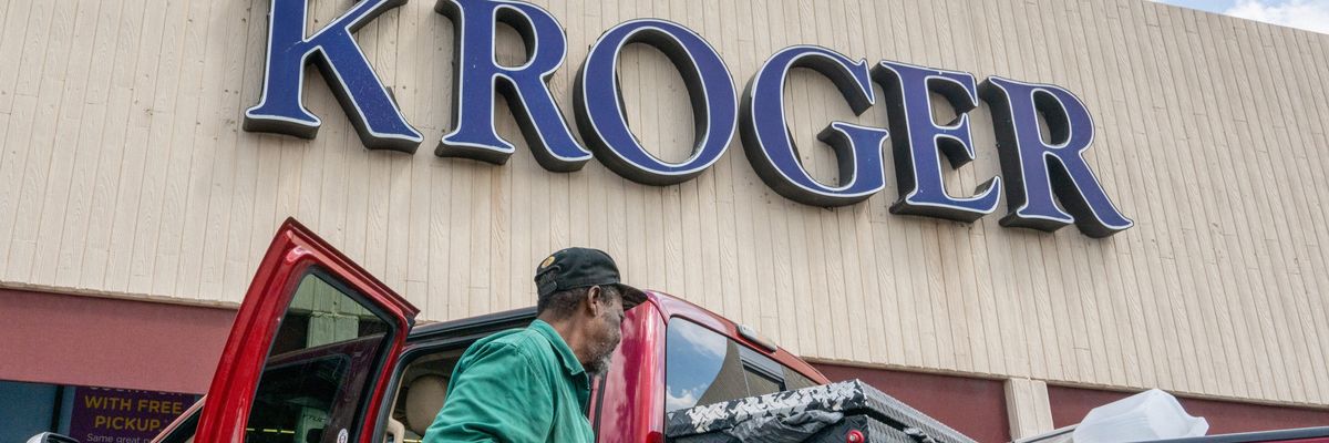 A customer loads his truck after shopping at a Kroger grocery store
