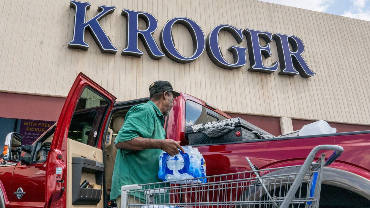 A customer loads his truck after shopping at a Kroger grocery store