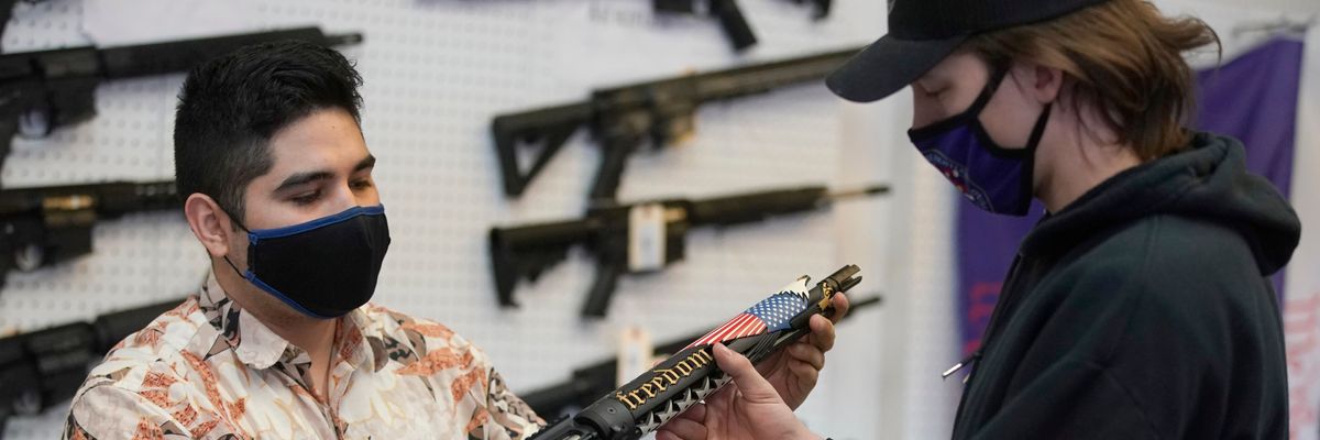 A customer looks at a custom-made AR-15-style rifle at Davidson Defense in Orem, Utah on February 4, 2021.