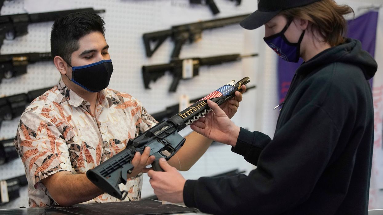A customer looks at a custom-made AR-15-style rifle at Davidson Defense in Orem, Utah on February 4, 2021.