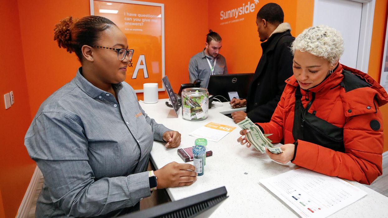 A customer makes a purchase at Sunnyside Cannabis Dispensary