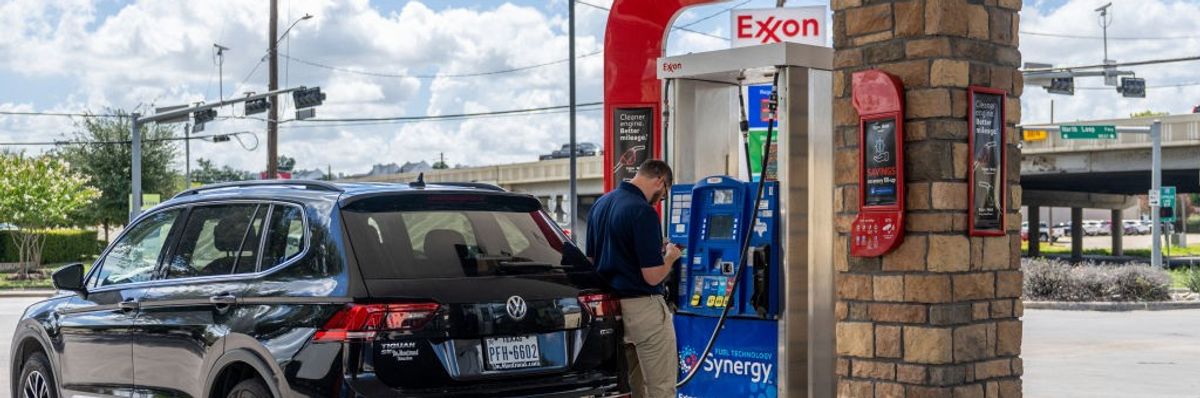 A customer pumps gas at an Exxon gas station