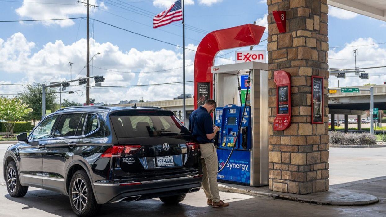 A customer pumps gas at an Exxon gas station
