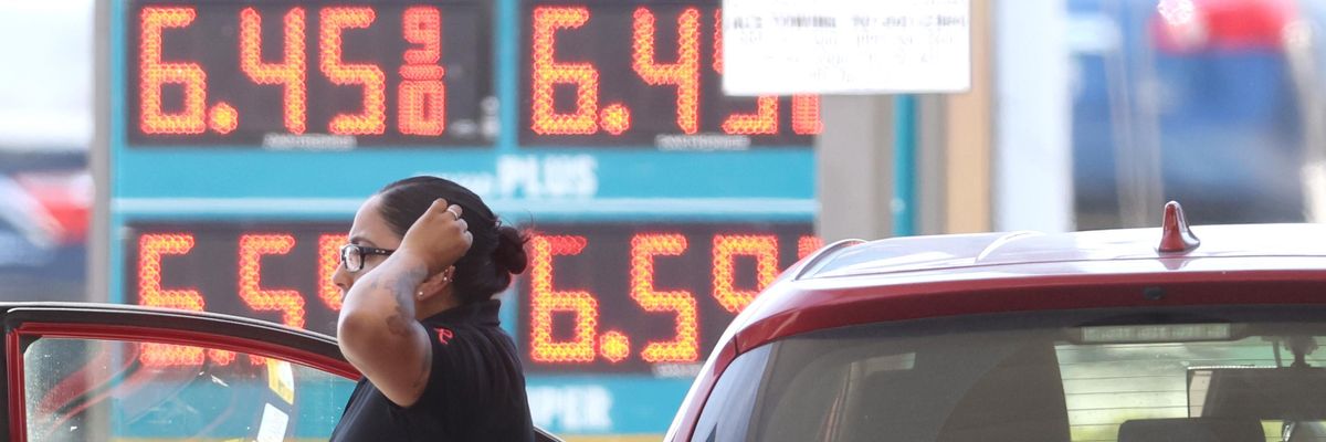 A customer refuels their car amid high gas prices.