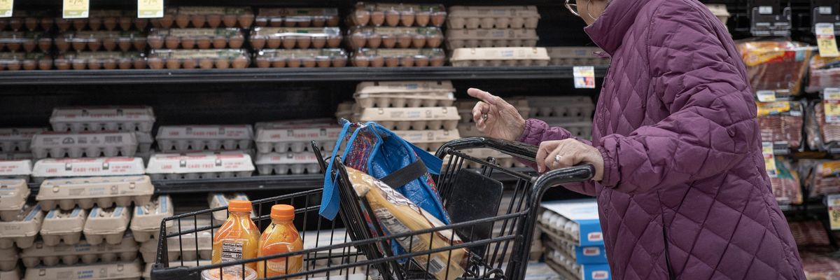 A customer shops for eggs at a grocery store