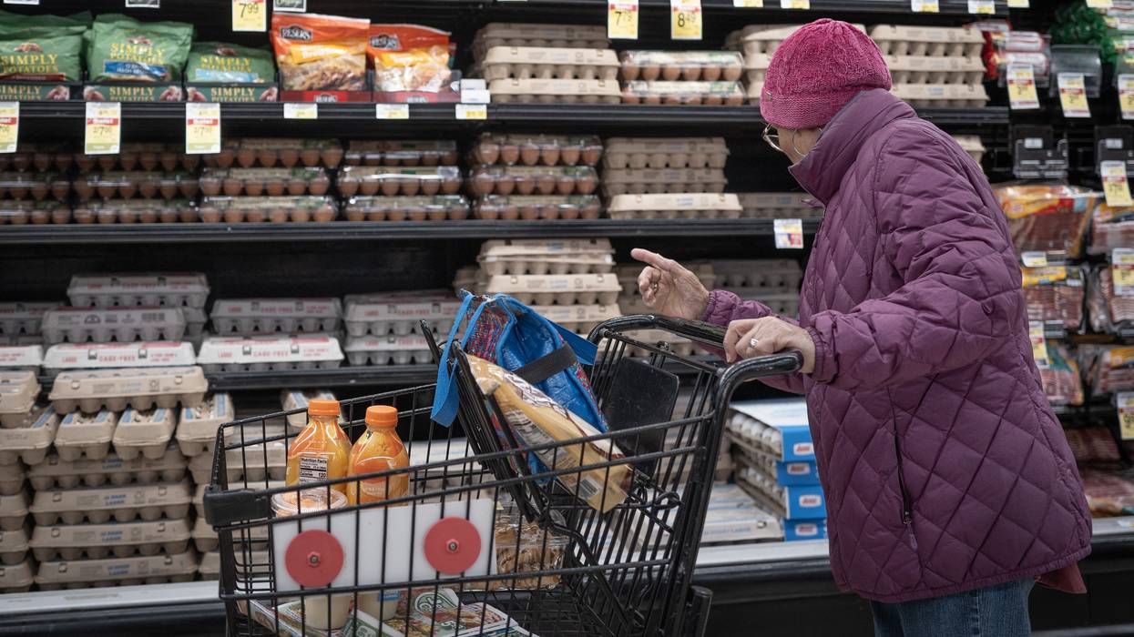 A customer shops for eggs at a grocery store