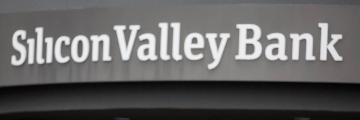 A customer stands outside of a shuttered Silicon Valley Bank