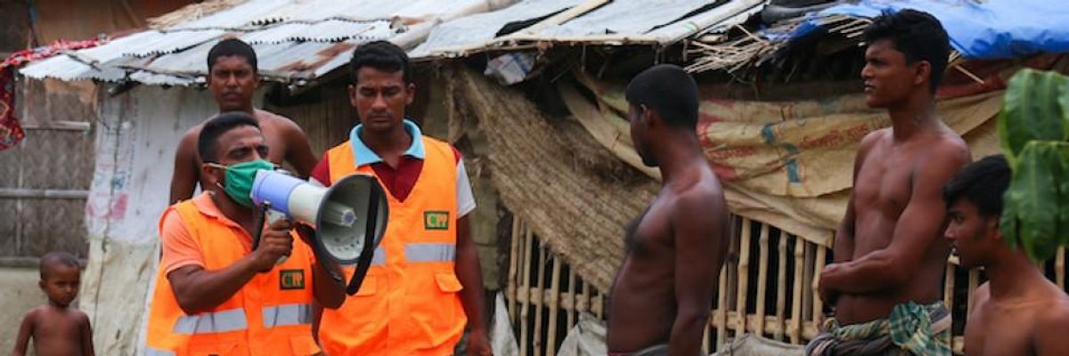 A Cyclone Preparedness Programme (CPP) volunteer uses a megaphone to urge residents to evacuate to shelters ahead of the expected landfall of Cyclone Amphan in Khulna on May 19, 2020