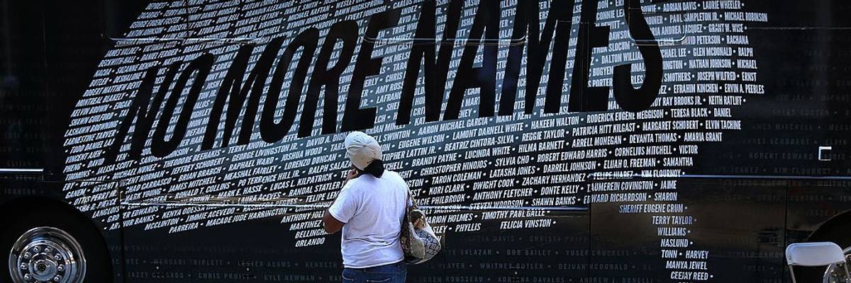 A demonstrater reads names of those killed by gun violence that form a U.S. map.