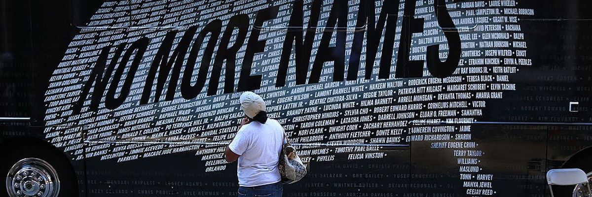 A demonstrater reads names of those killed by gun violence that form a U.S. map.