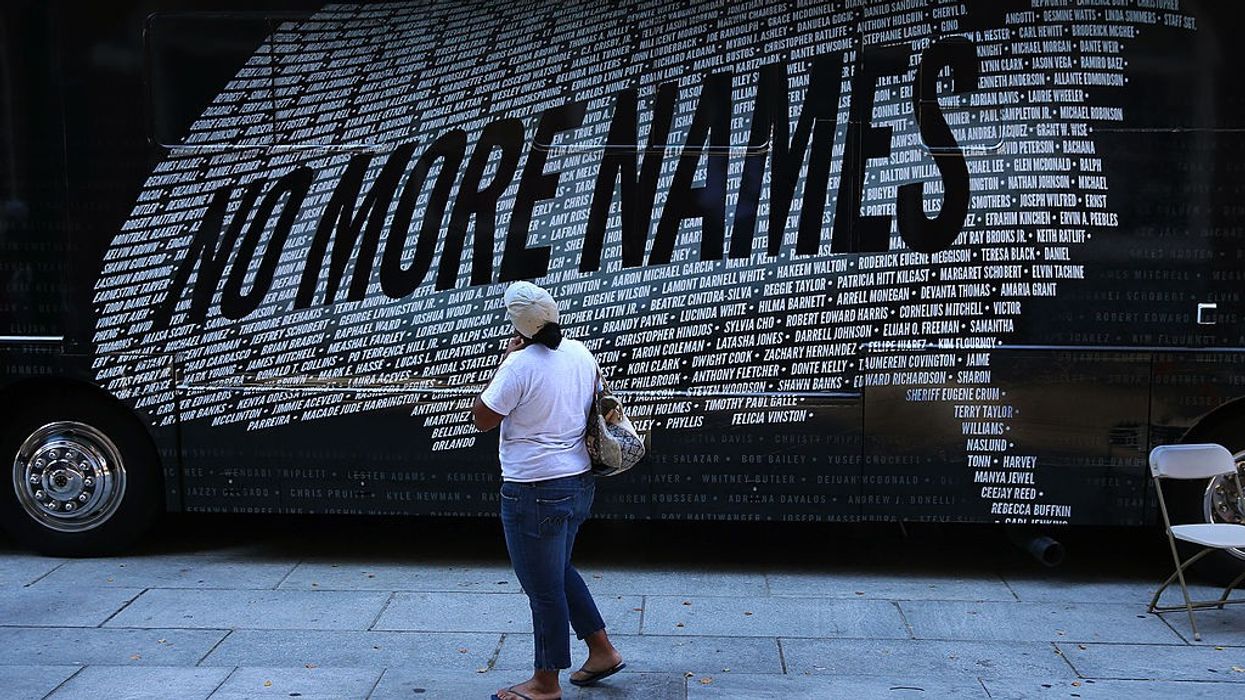 A demonstrater reads names of those killed by gun violence that form a U.S. map.