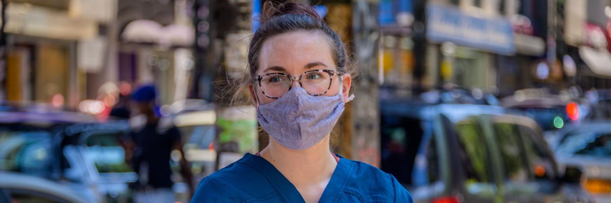 A demonstrator holds a "Medicaid Cuts Kill" sign at a rally