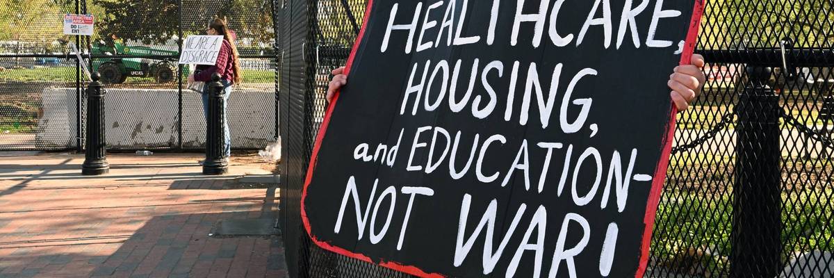 A demonstrator holds a placard in front of the White House