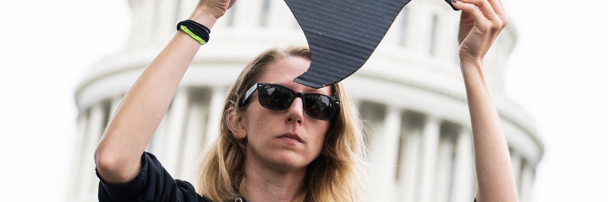 A demonstrator holds a sign condemning Republican Sen. Ted Cruz