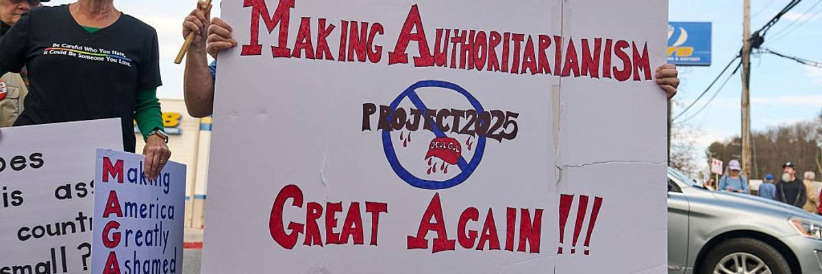 a demonstrator holds a sign opposing Project 2025