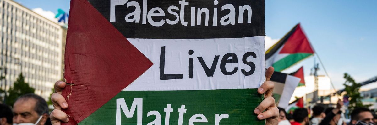 A demonstrator holds up a sign reading, "Palestinian Lives Matter."