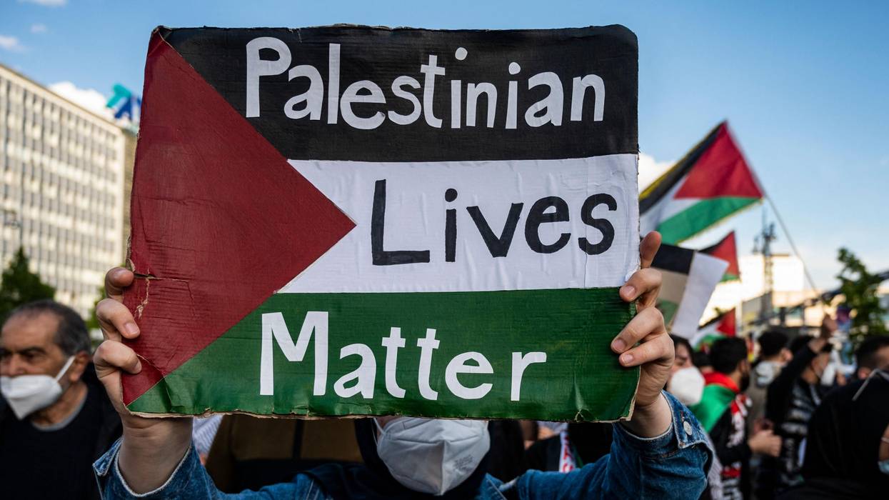 A demonstrator holds up a sign reading, "Palestinian Lives Matter."