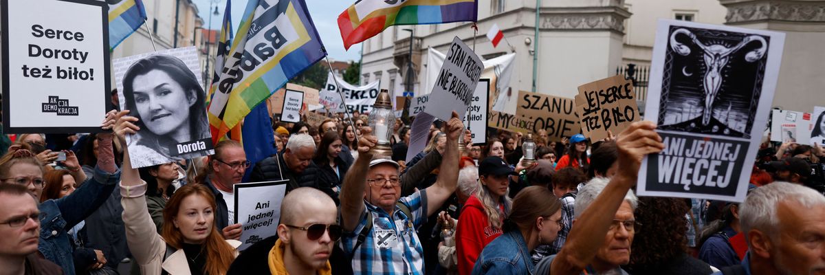 A demonstrator holds up an image showing the late Dorota Lalik on June 14, 2023, as people take to the streets in downtown Warsaw and other Polish cities to protest the nation's abortion restrictions. ​