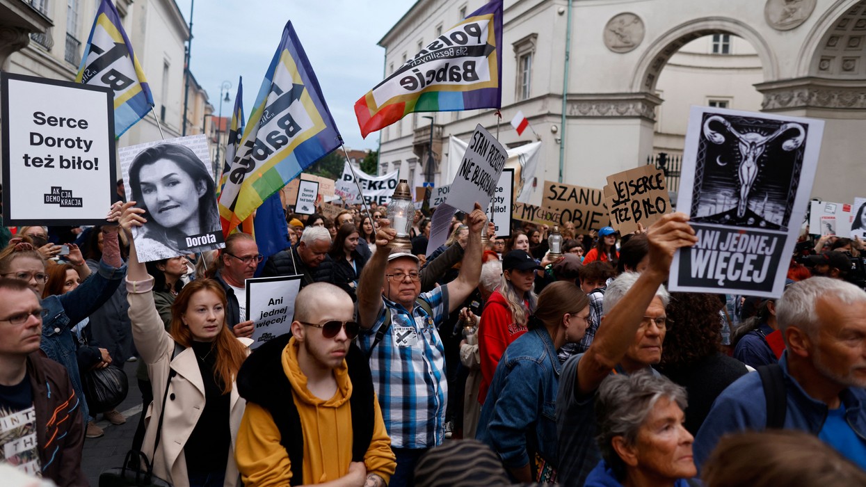 A demonstrator holds up an image showing the late Dorota Lalik on June 14, 2023, as people take to the streets in downtown Warsaw and other Polish cities to protest the nation's abortion restrictions. 