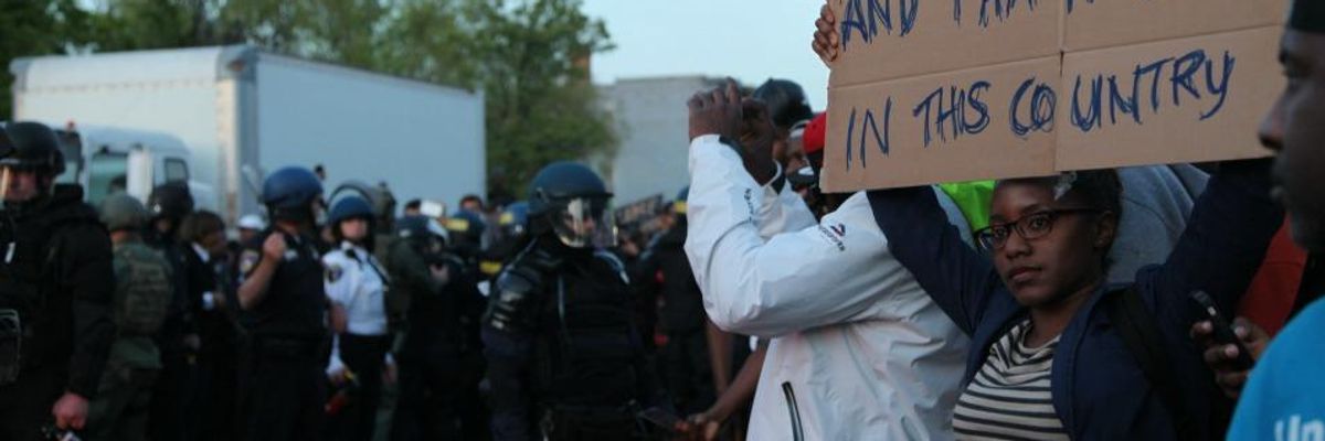 A demonstrator in Baltimore, Maryland holds a sign during the protests which followed the police killing of Freddie Gray