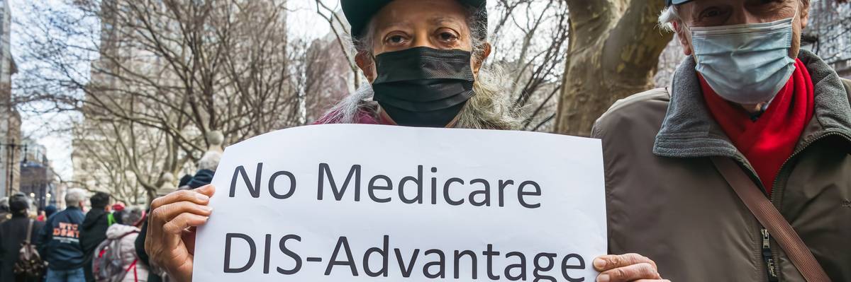 A demonstrator is seen holding a sign outside of a hearing at New York City Hall