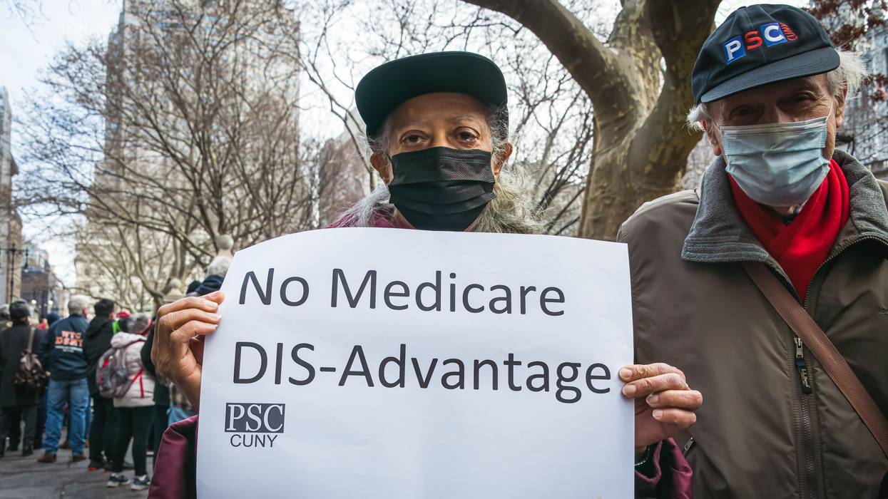 A demonstrator is seen holding a sign outside of a hearing at New York City Hall